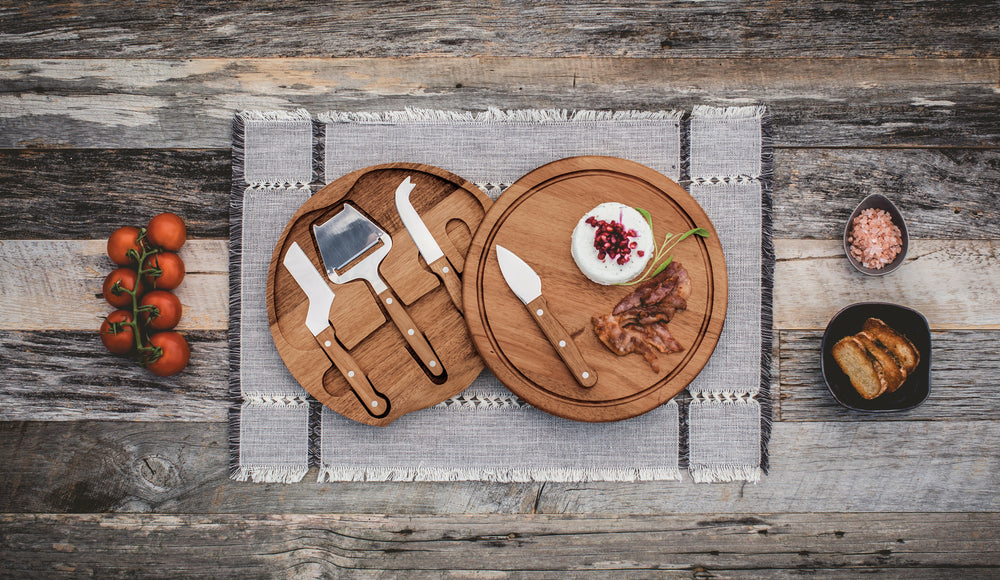 cheeseboard and tool set on the table with meat and cheese on the board